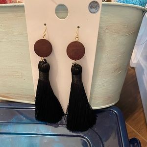 Black tassel earring with wooden disk.